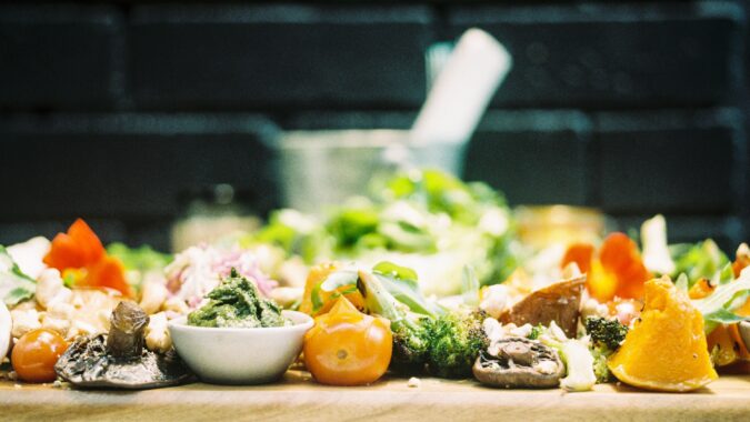 waste food fruit and vegetables on a chopping board.