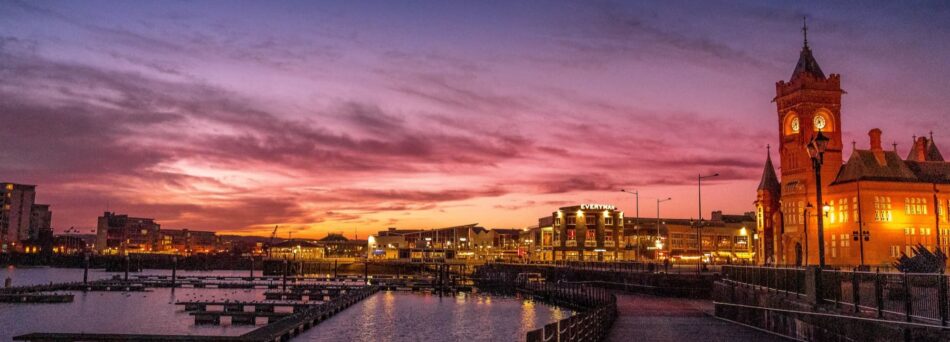 Cardiff bay at sunset with church in foreground.