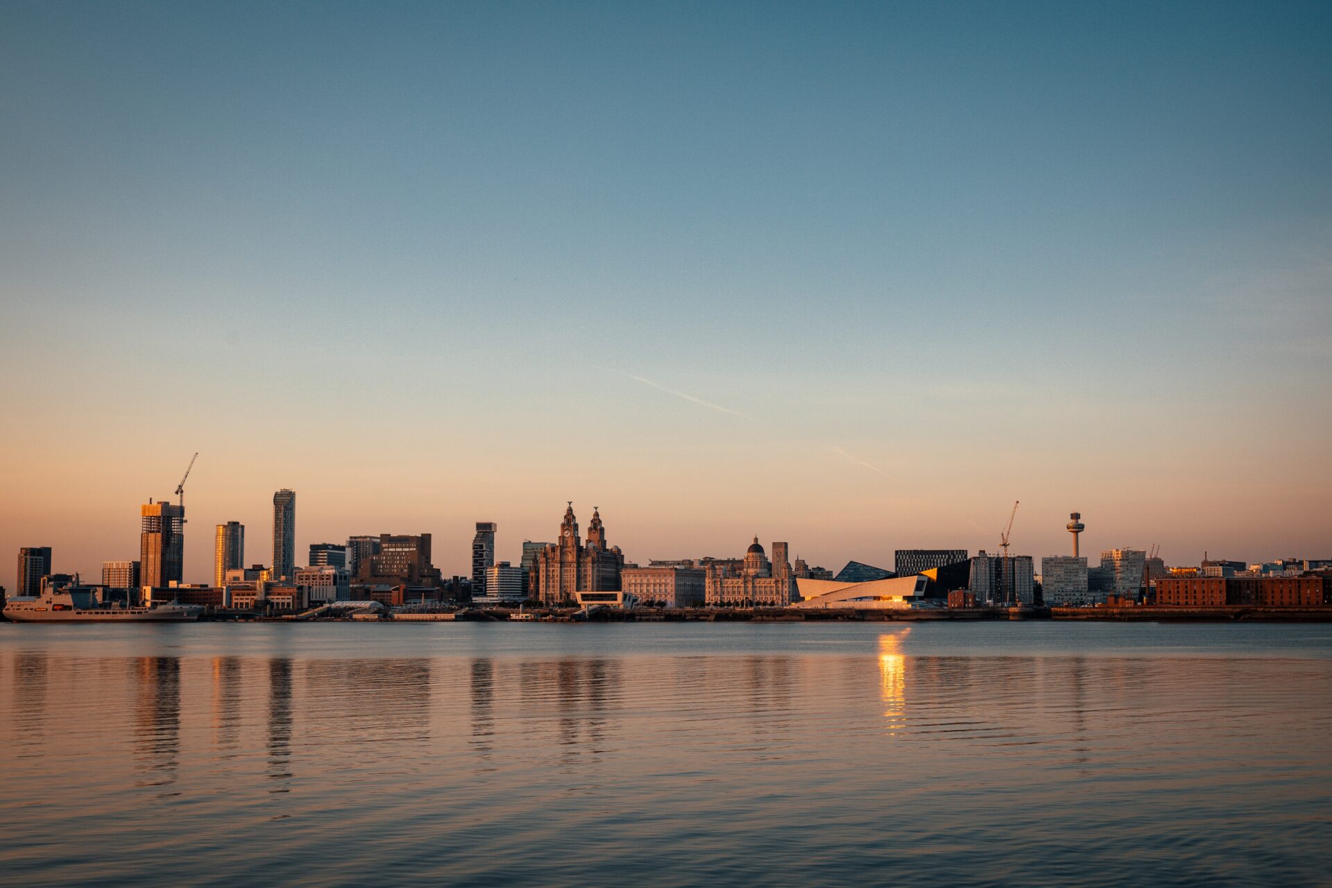 Liverpool skyline over the River Mersey at sunset.