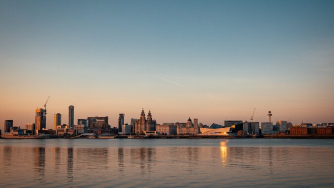 Liverpool skyline over the River Mersey at sunset.