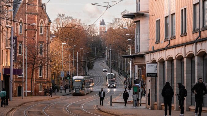 trams coming down hill in Nottingham city centre at sunset.