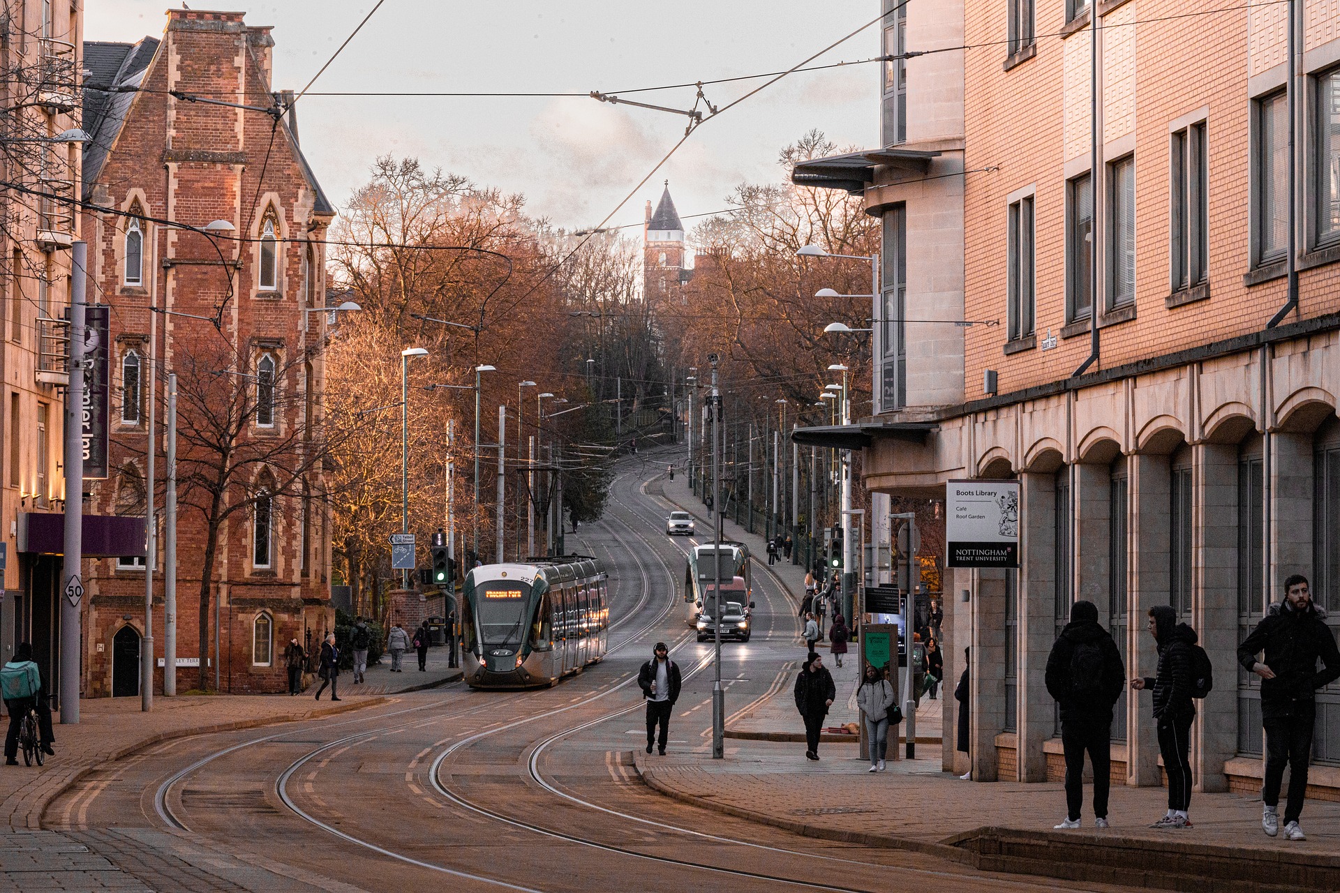 trams coming down hill in Nottingham city centre at sunset.