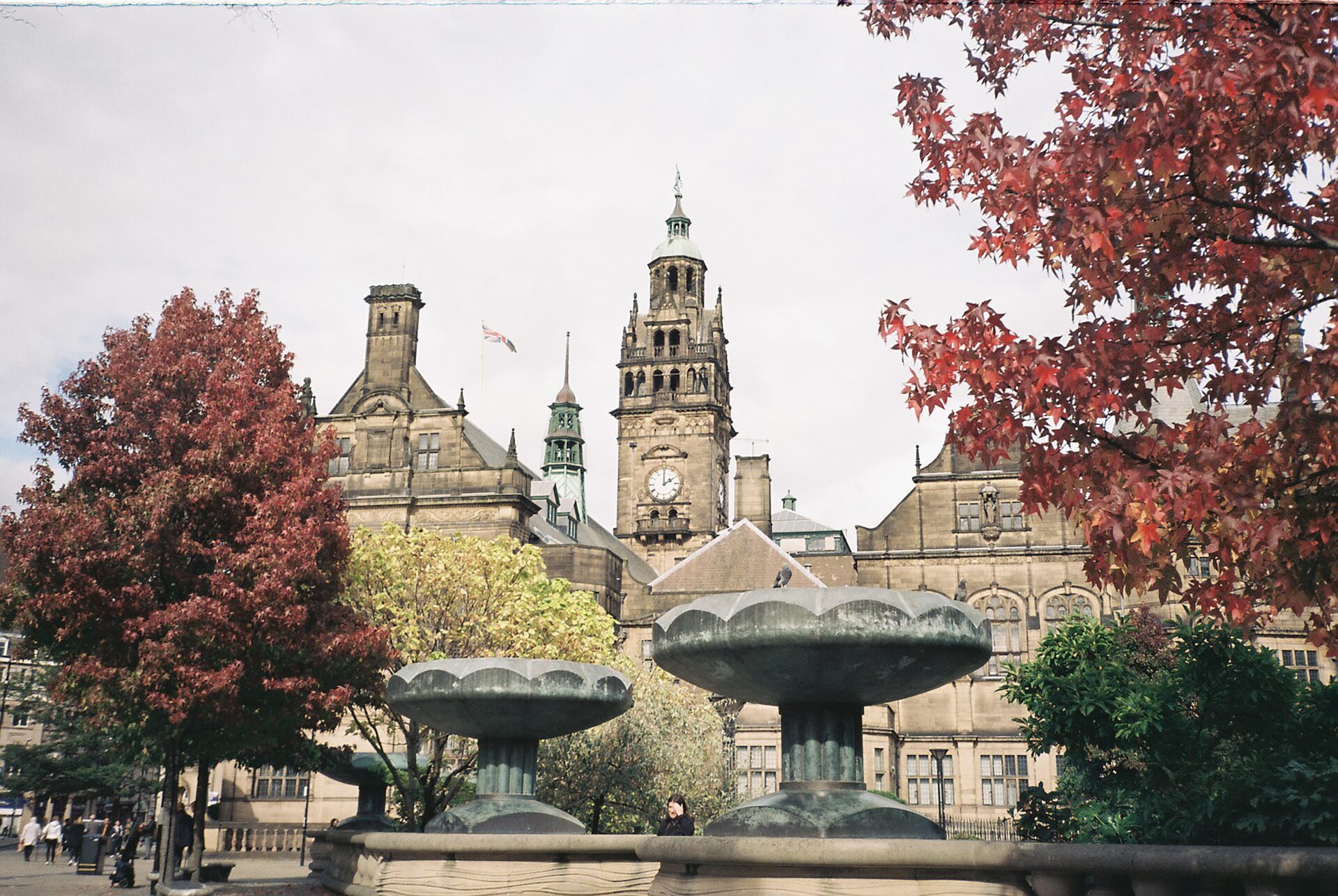 Sheffield town hall with fountains and trees in foreground.