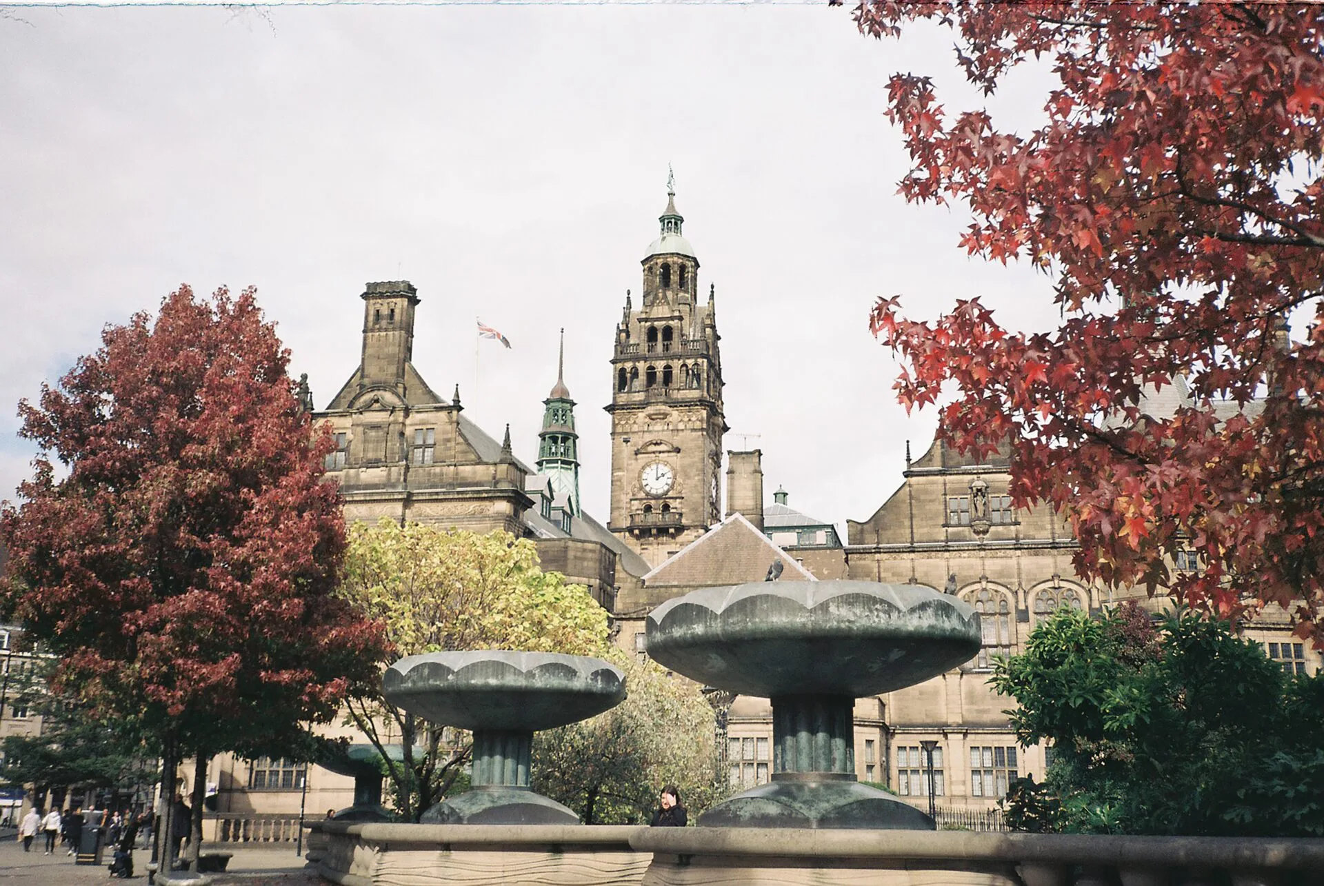 Sheffield town hall with fountains and trees in foreground.