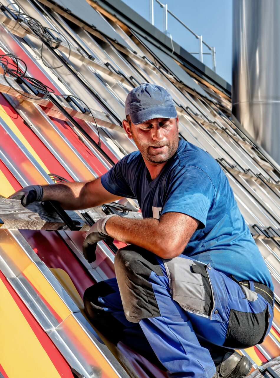 man fixing roof in workwear.