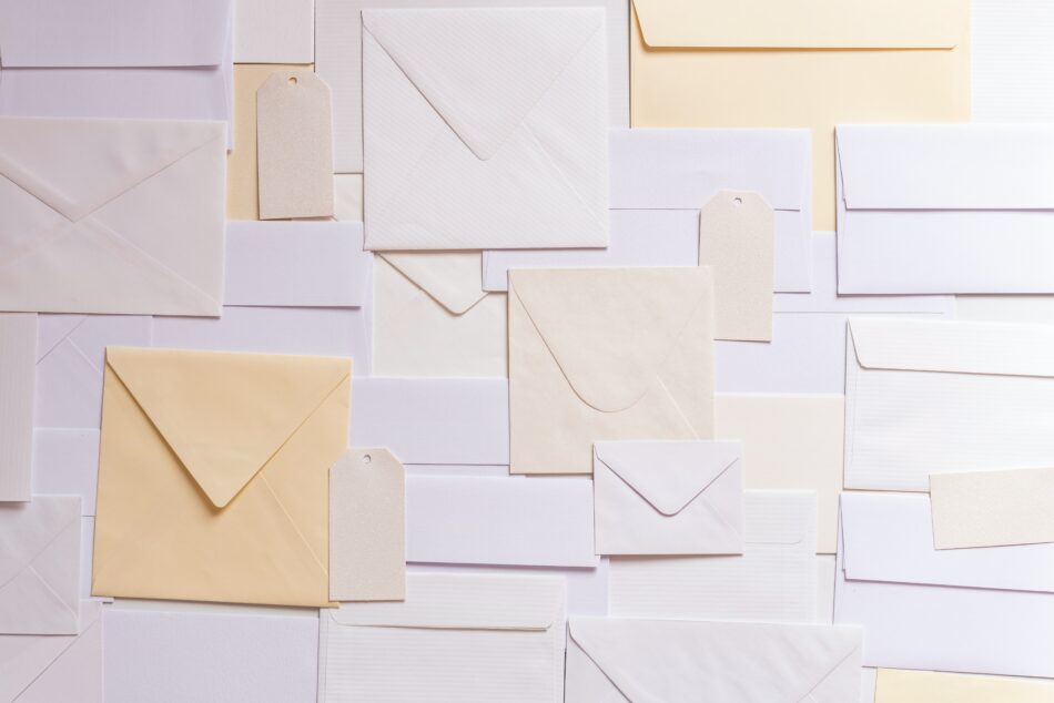 light coloured envelopes on white background.