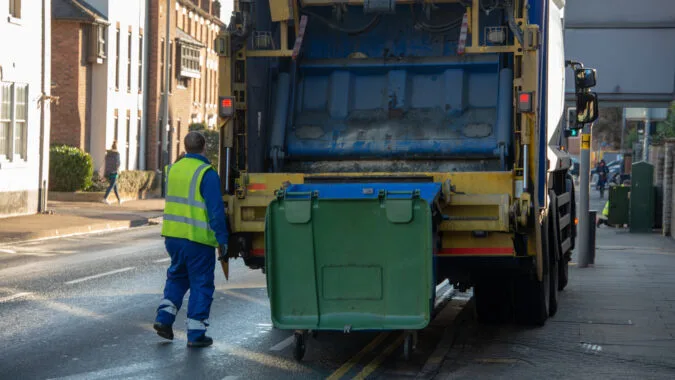 commercial waste truck collecting business bins