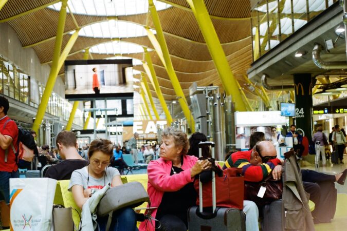 people sat waiting in airport.