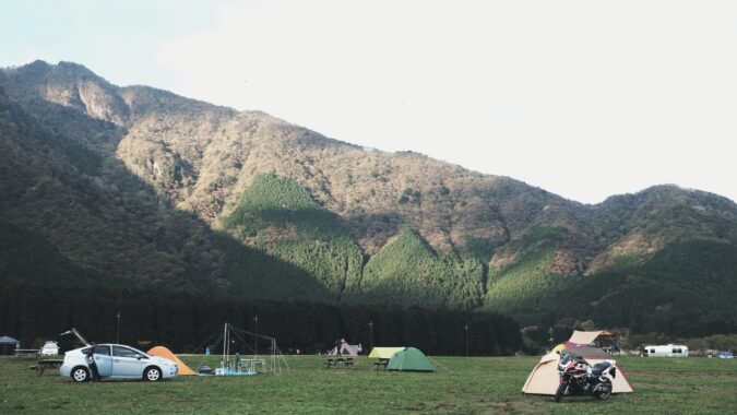 tents camping on grass.