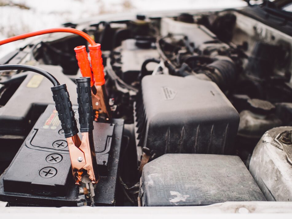 car battery hooked up to jump leads.