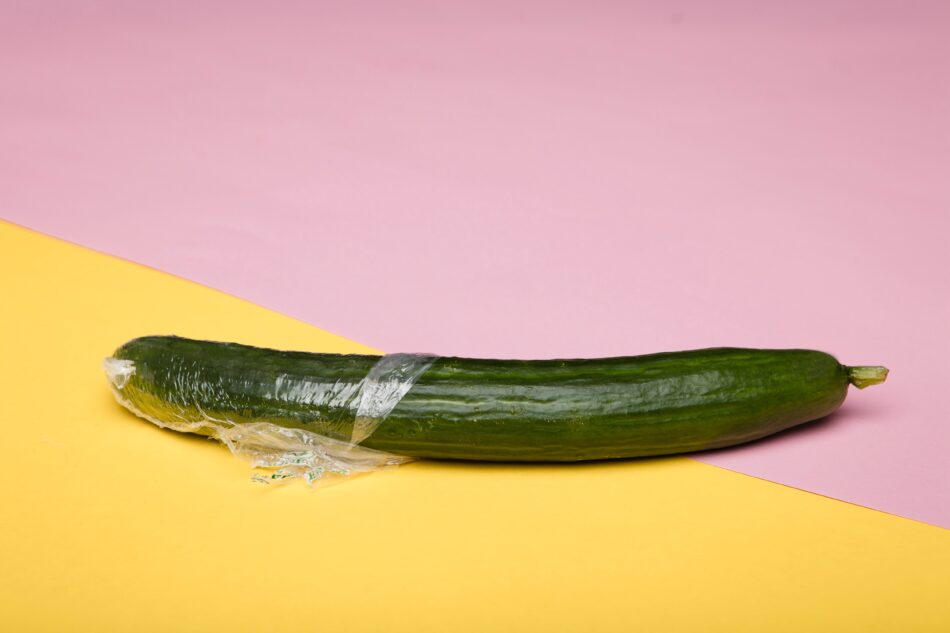 cucumber with cling film half unwrapped.