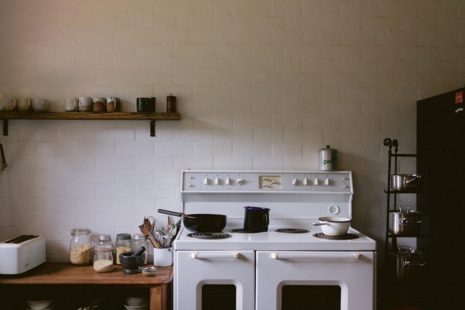 white oven and hob with pans on.