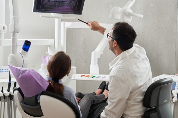 dentist showing patient x-ray.