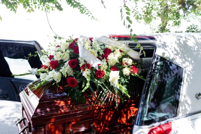coffin in back of funeral car.