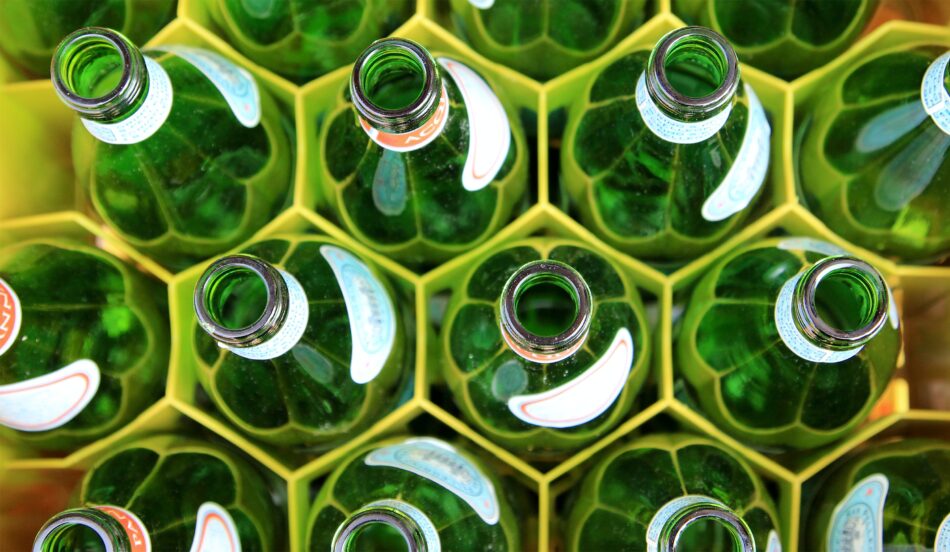 overhead view of green glass bottles in a crate.