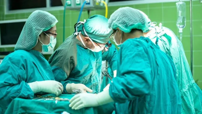 surgeons operating in a hospital.