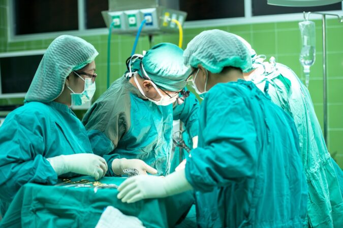 surgeons operating in a hospital.