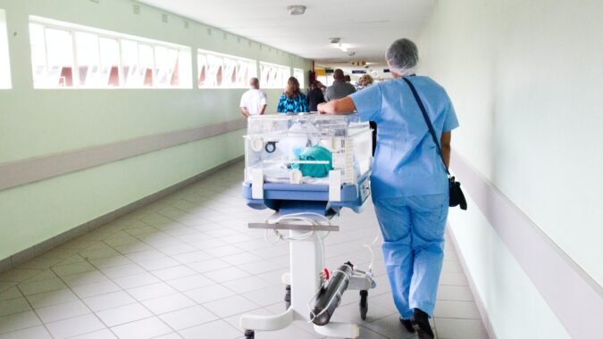 doctor walking with hospital bed.