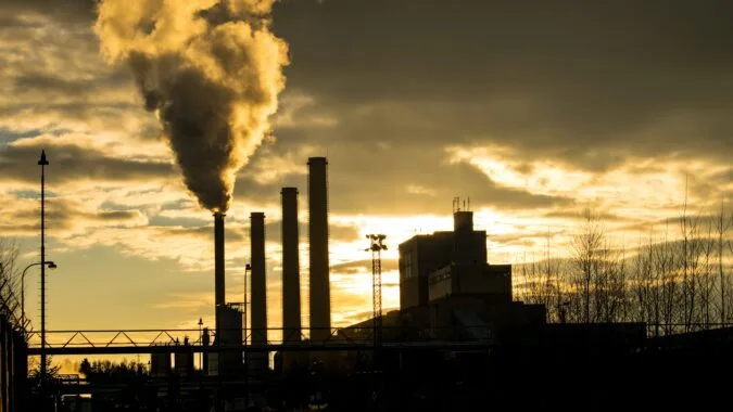silhouette of power plant and smoke.