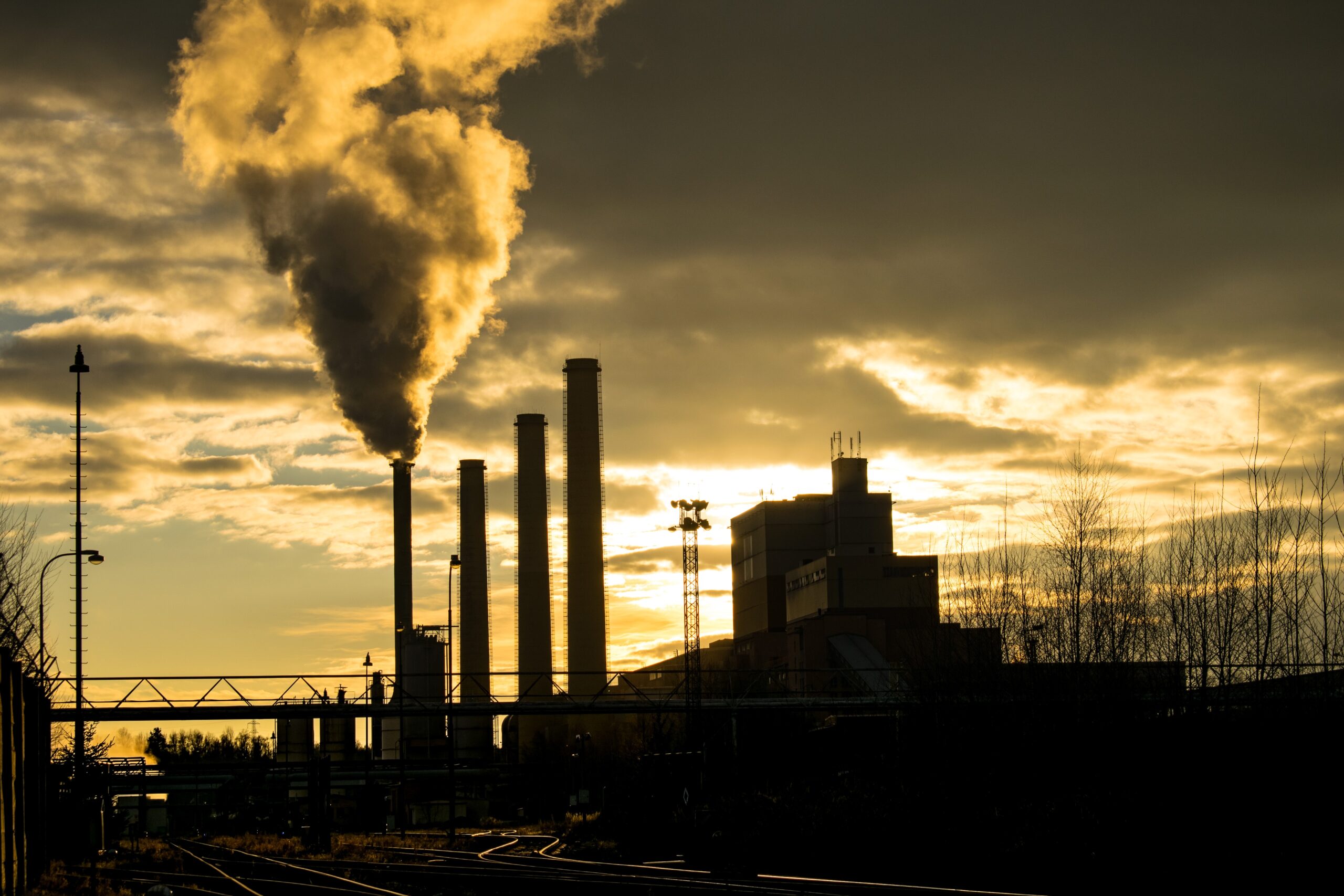 silhouette of power plant and smoke.