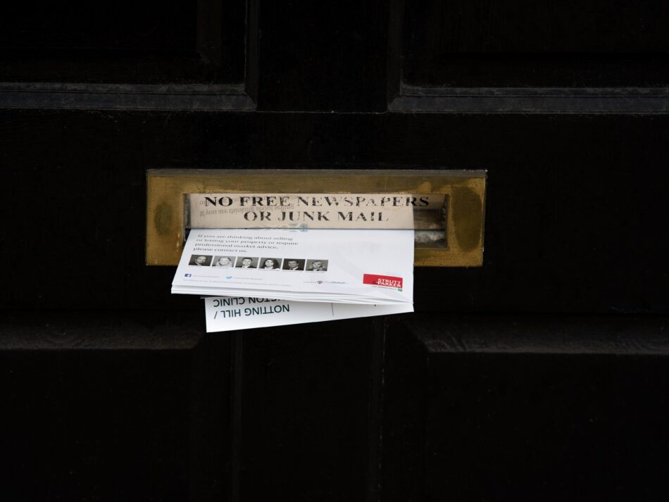 junk mail halfway in letter box.