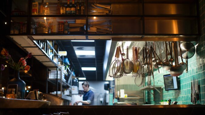 man working in commercial kitchen.