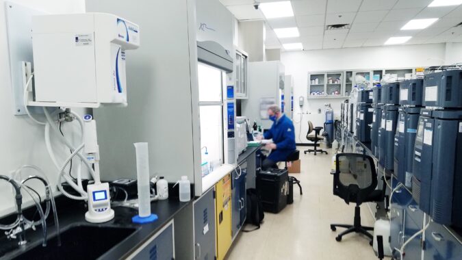 man sat down working in laboratory.