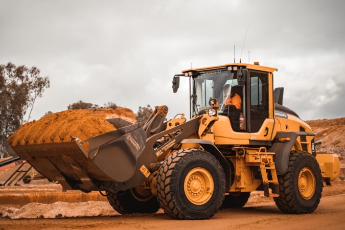 digger moving soil on construction site.