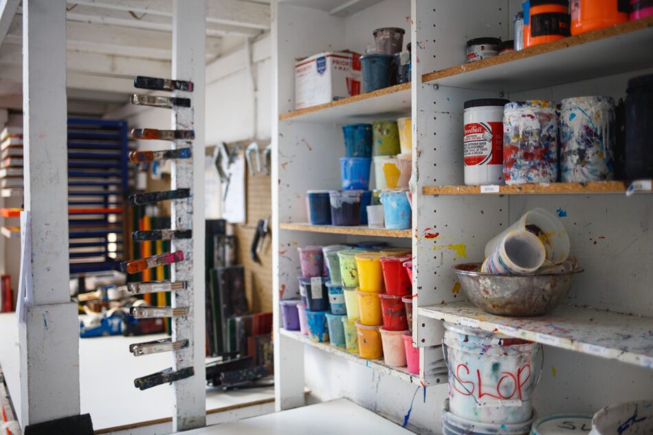 paint cans and tins on shelves.