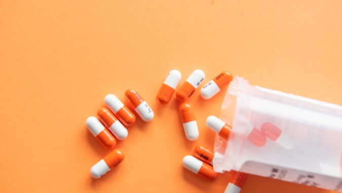 pills spilling out of pill bottle.