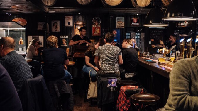 people sat drinking in a pub.