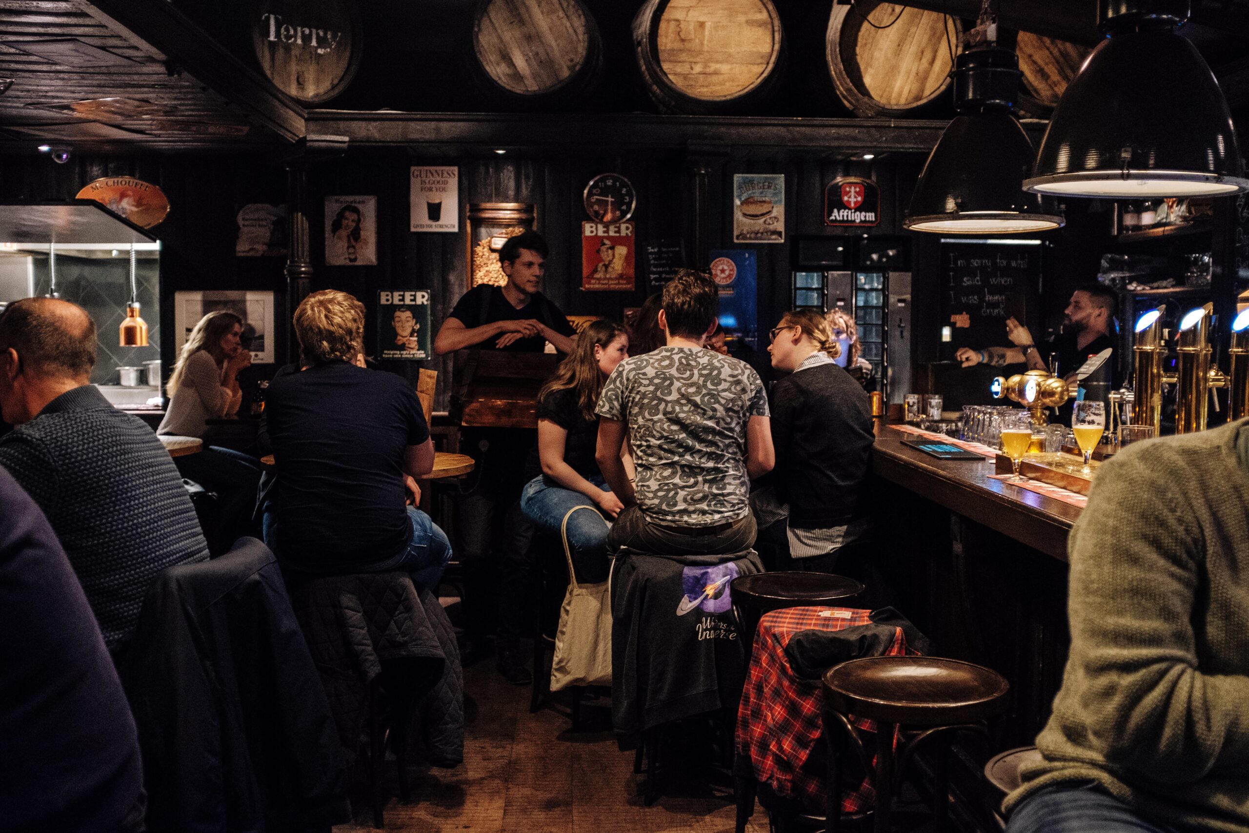 people sat drinking in a pub.