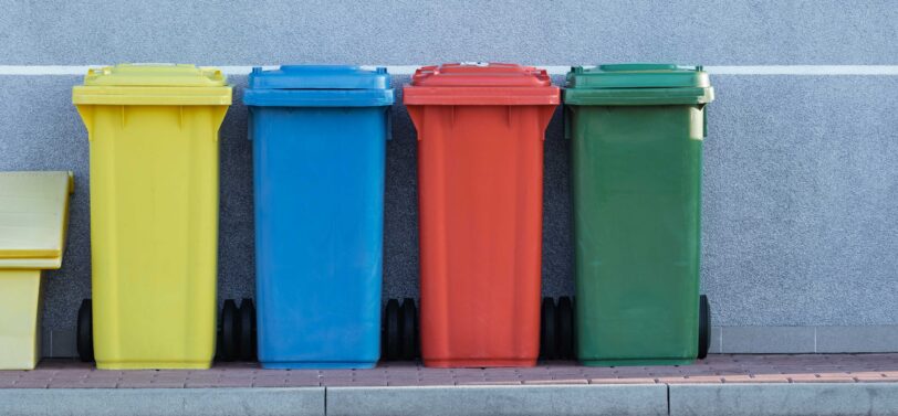 four standard wheelie bins in a line.