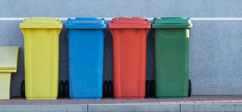 four standard wheelie bins in a line.