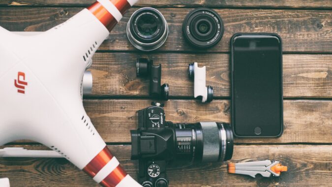 drone, phone, and camera on a table.