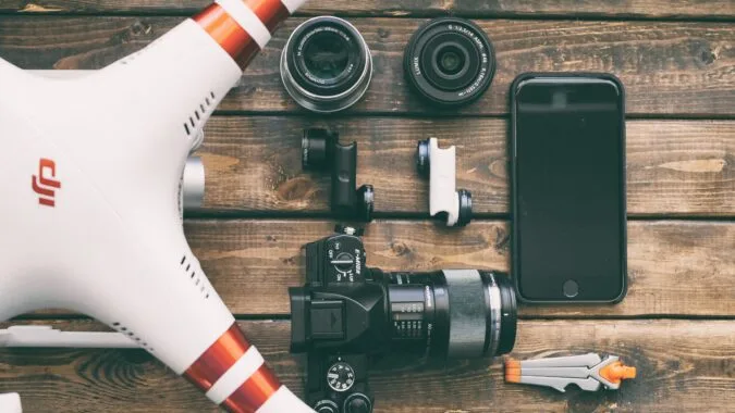drone, phone, and camera on a table.