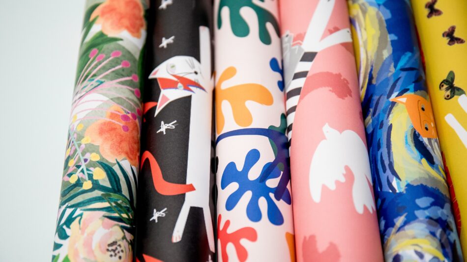 six rolls of colourful wrapping paper.