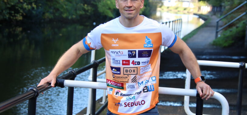 Kevin Sinfield wearing ultra 7in7 running top.