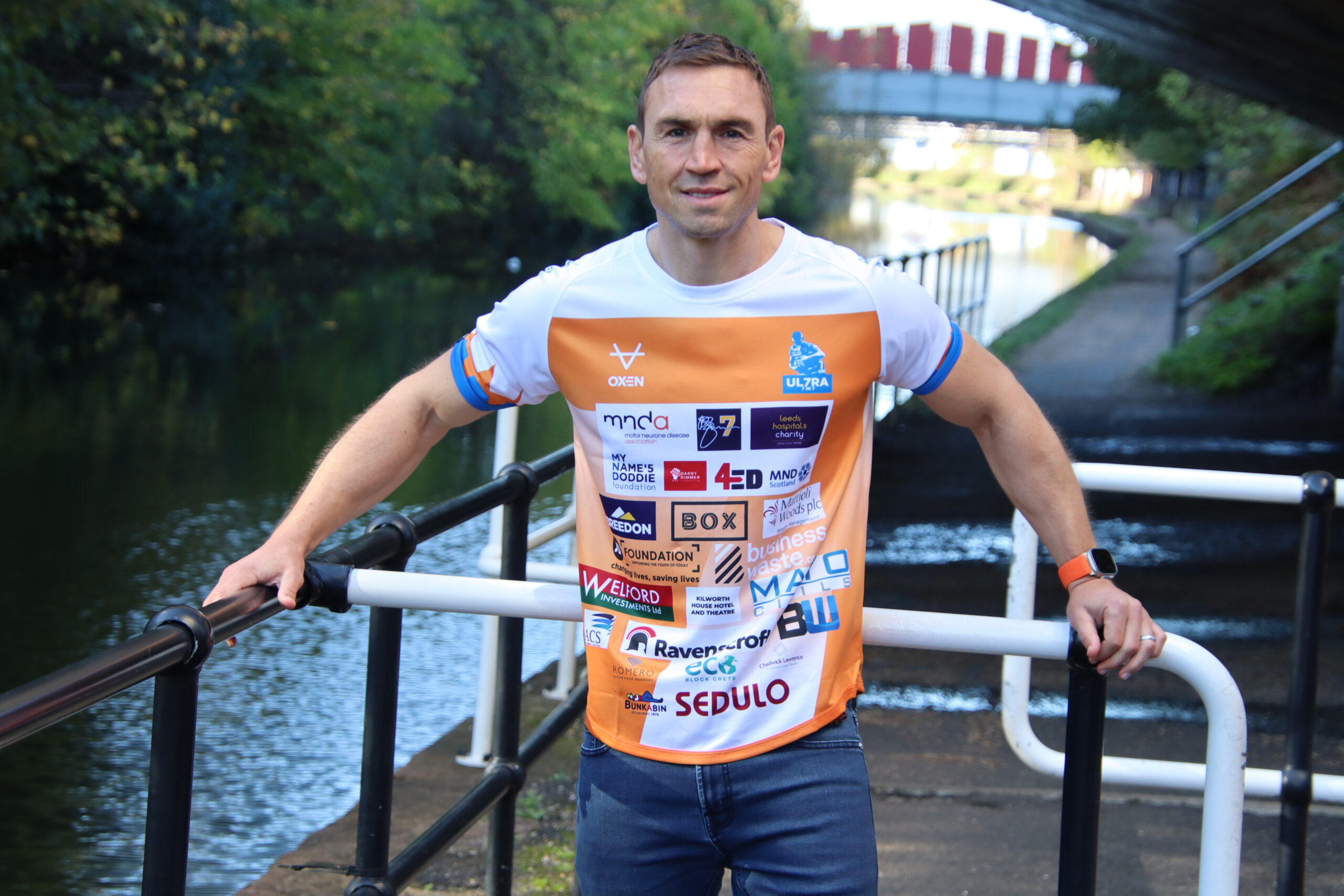 Kevin Sinfield wearing ultra 7in7 running top.
