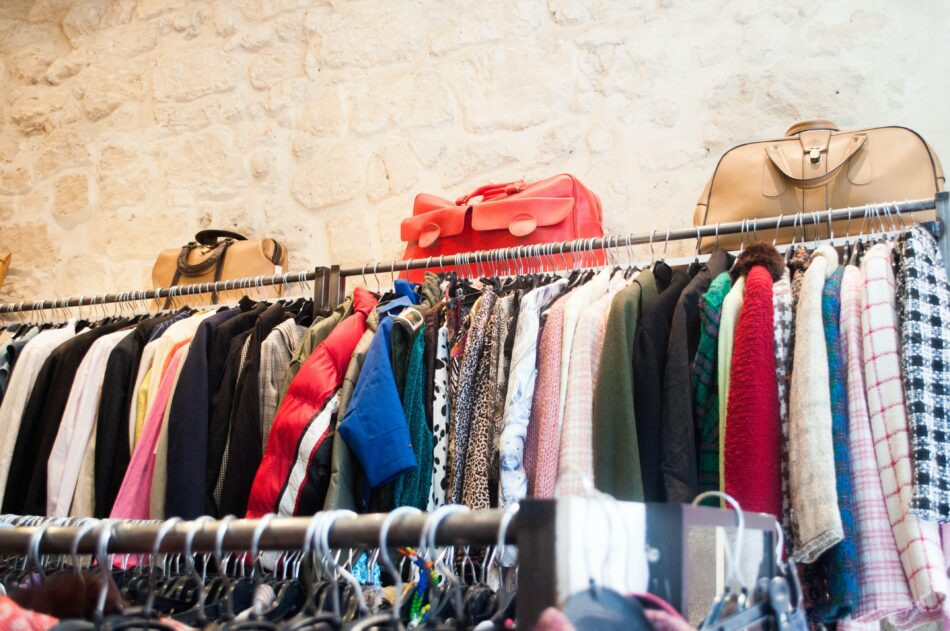 clothes on charity shop rail.