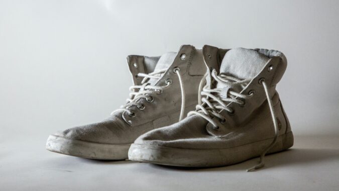 old pair of white canvas trainers.