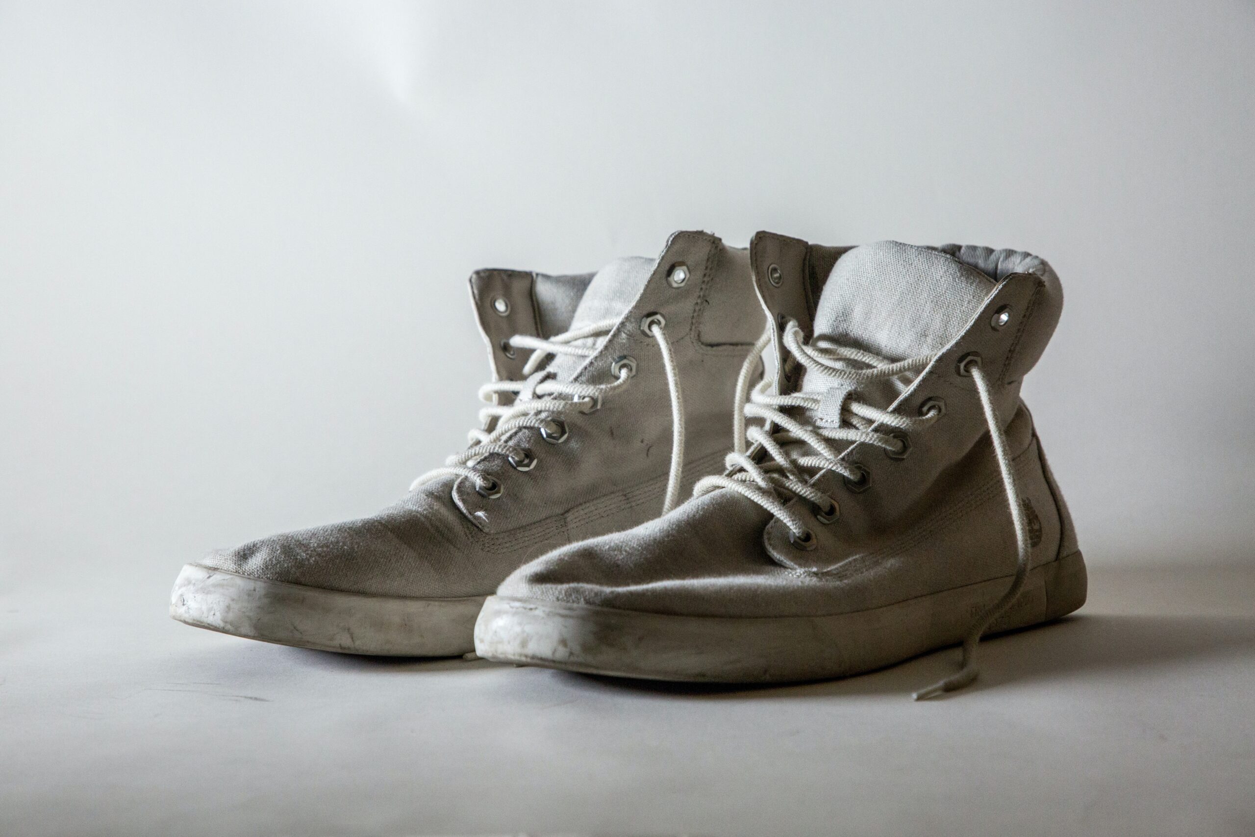 old pair of white canvas trainers.