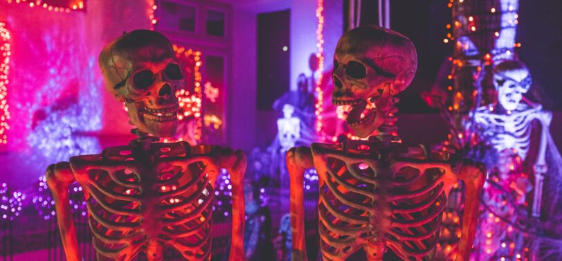 two plastic skeletons in Halloween house.