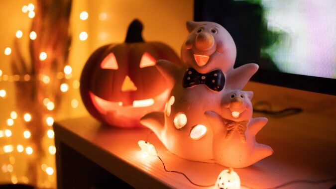 pumpkin and ghost light on shelf.