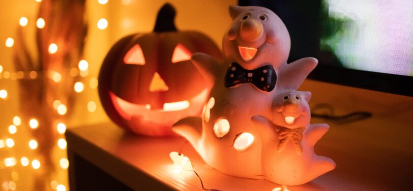 pumpkin and ghost light on shelf.