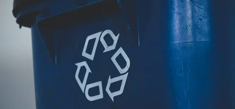 recycling logo on front of bin.