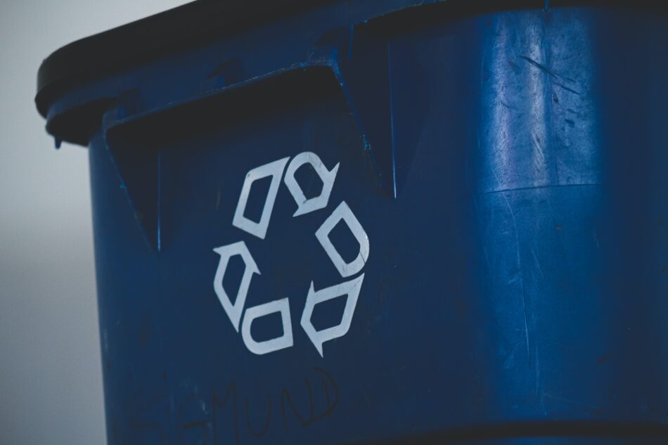 recycling logo on front of bin.