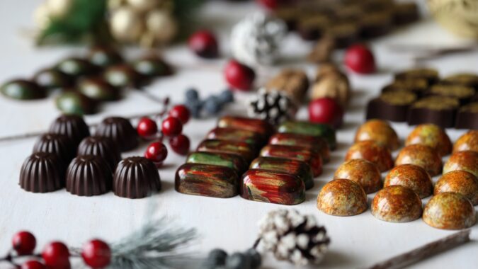 lines of individual Christmas chocolates n a table.