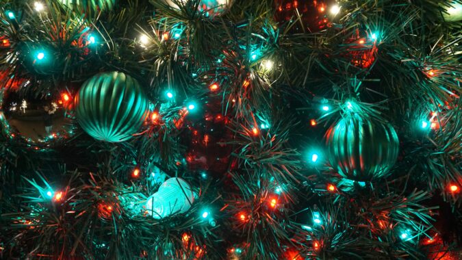 baubles lights and tinsel in christmas tree.