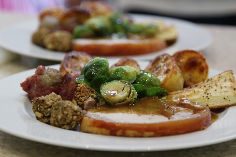 christmas dinner with turkey sprouts and stuffing on a plate.